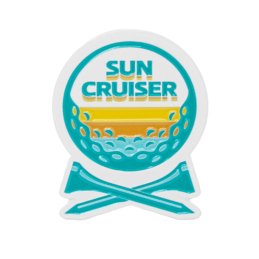 Sun Cruiser golf ball marker with colorful sunset, ocean waves, and crossed clubs design