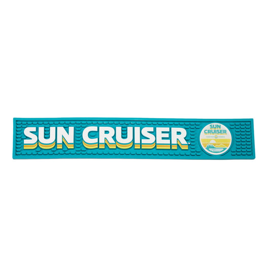 Blue bar mat featuring written Sun Cruiser logo along it. Featured on the right of the bar mat is the Sun Cruiser circle sun logo.