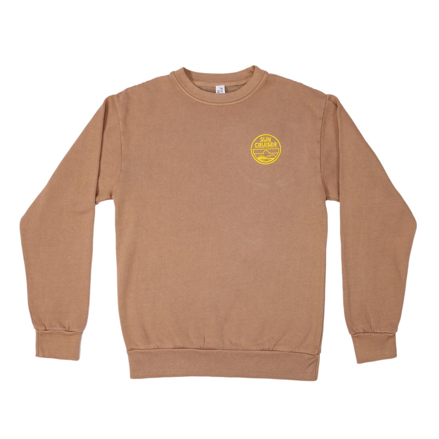 A flat lay of a light brown crewneck sweatshirt. On the left chest, there's a circular yellow logo that reads 'SUN CRUISER' in a stacked format. The logo also contains a small illustration of a landscape with mountains, water, and trees.
