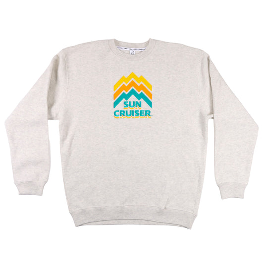 Cream colored Crewneck Sweatshirt with a centered Sun Cruiser logo. Line work on the logo is designed to look like a mountain range, in classic sun cruiser colors cyan, orange, and yellow.