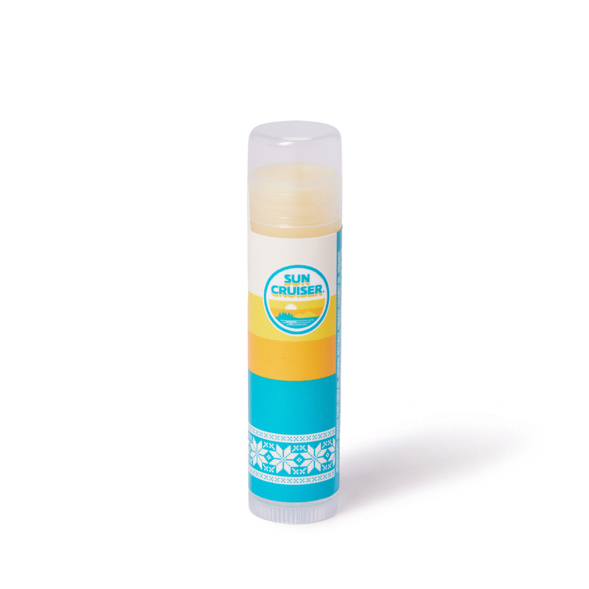 A single tube of Sun Cruiser lip balm with a white, yellow, and teal label, standing upright on a white background.