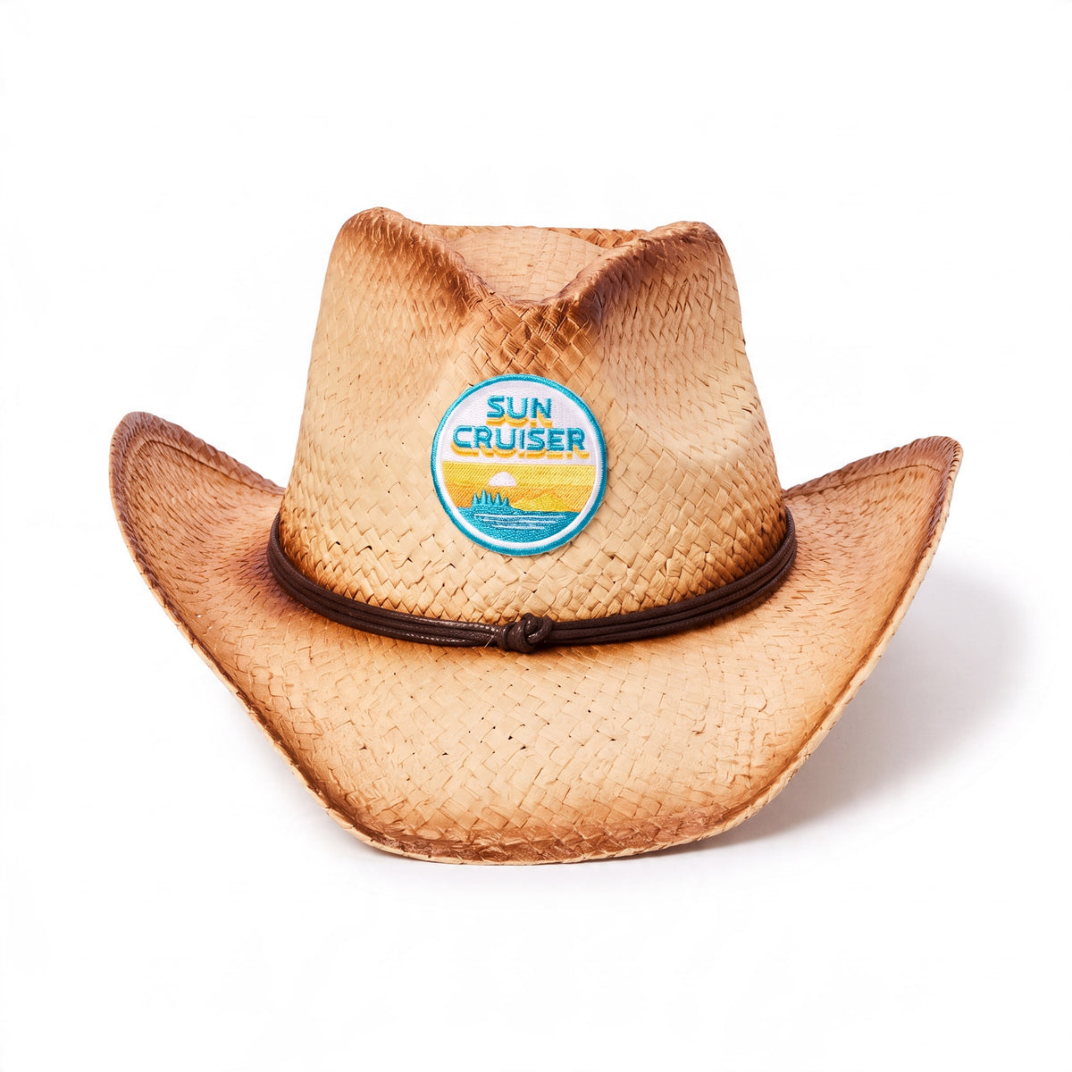 A natural straw cowboy hat with a dark brown band and a round blue and yellow 'Sun Cruiser' patch on the front, photographed on a clean white background.