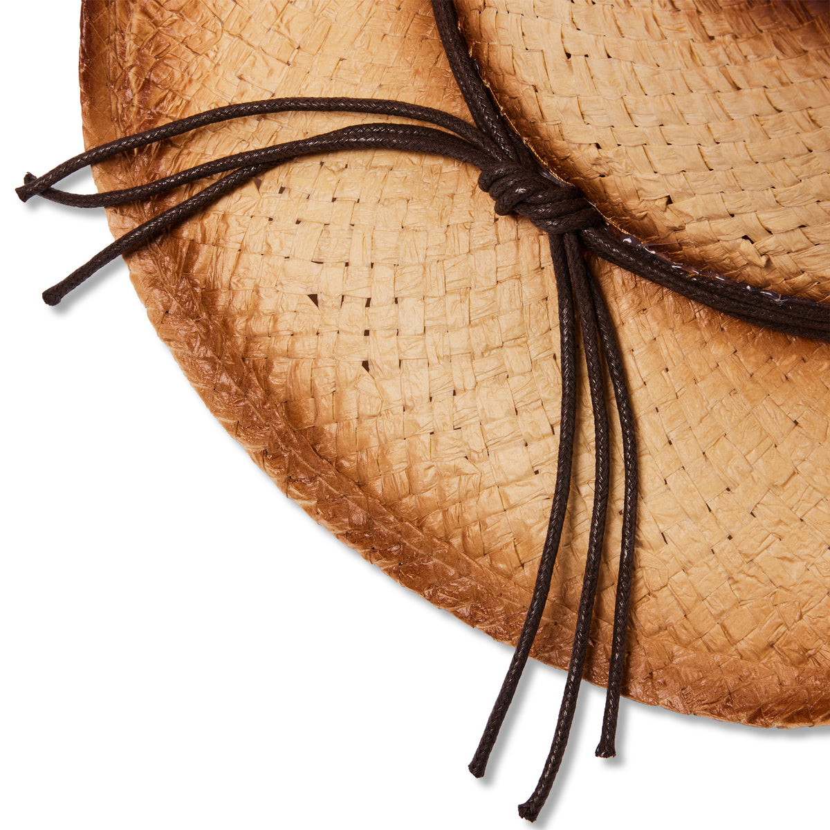 Close-up of a woven straw hat in a warm tan color with dark brown rope ties, shown on a plain white background.