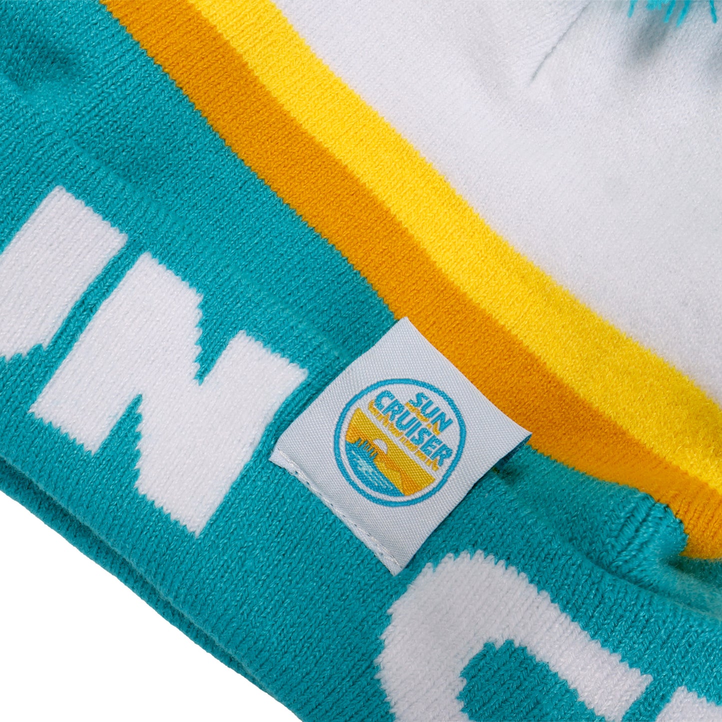 Close-up of a colorful beanie with a brand label on a white background