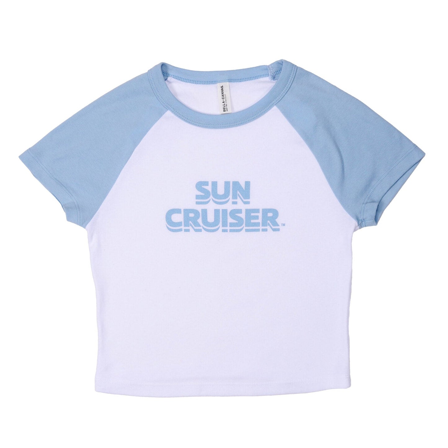 A white cropped t-shirt with light blue raglan sleeves and collar. The front of the shirt has the words 'SUN CRUISER' printed in light blue, stacked centrally.